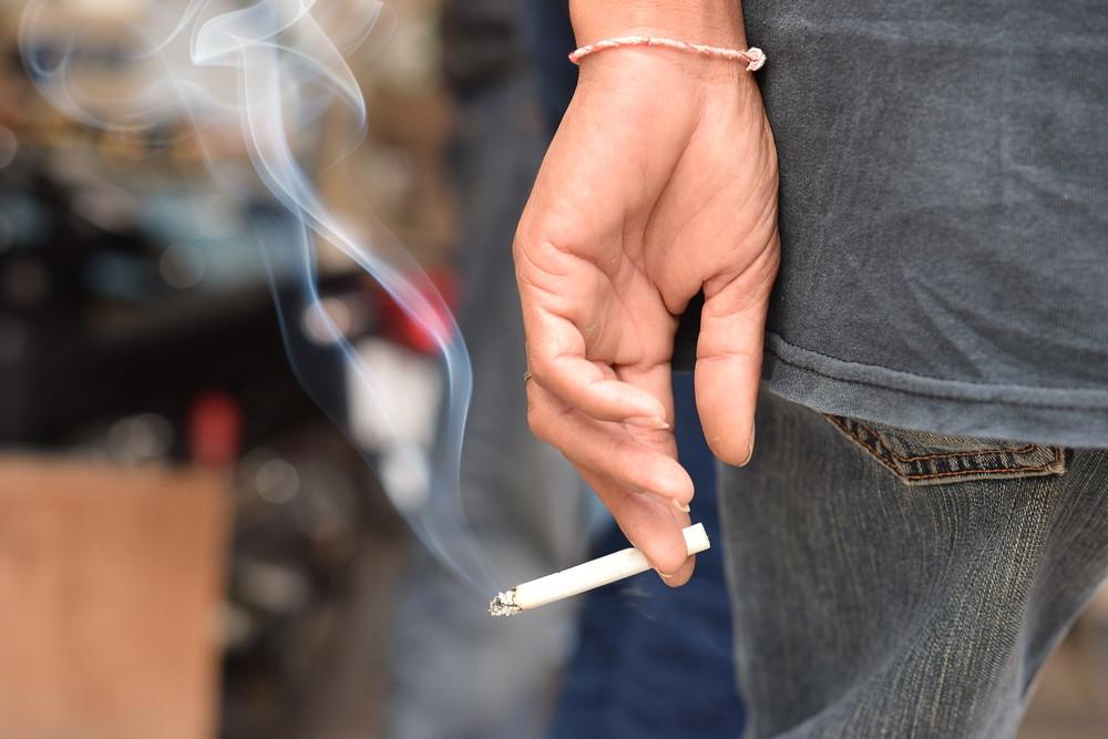 Image Of Cigarette In Man Hand With Smoke